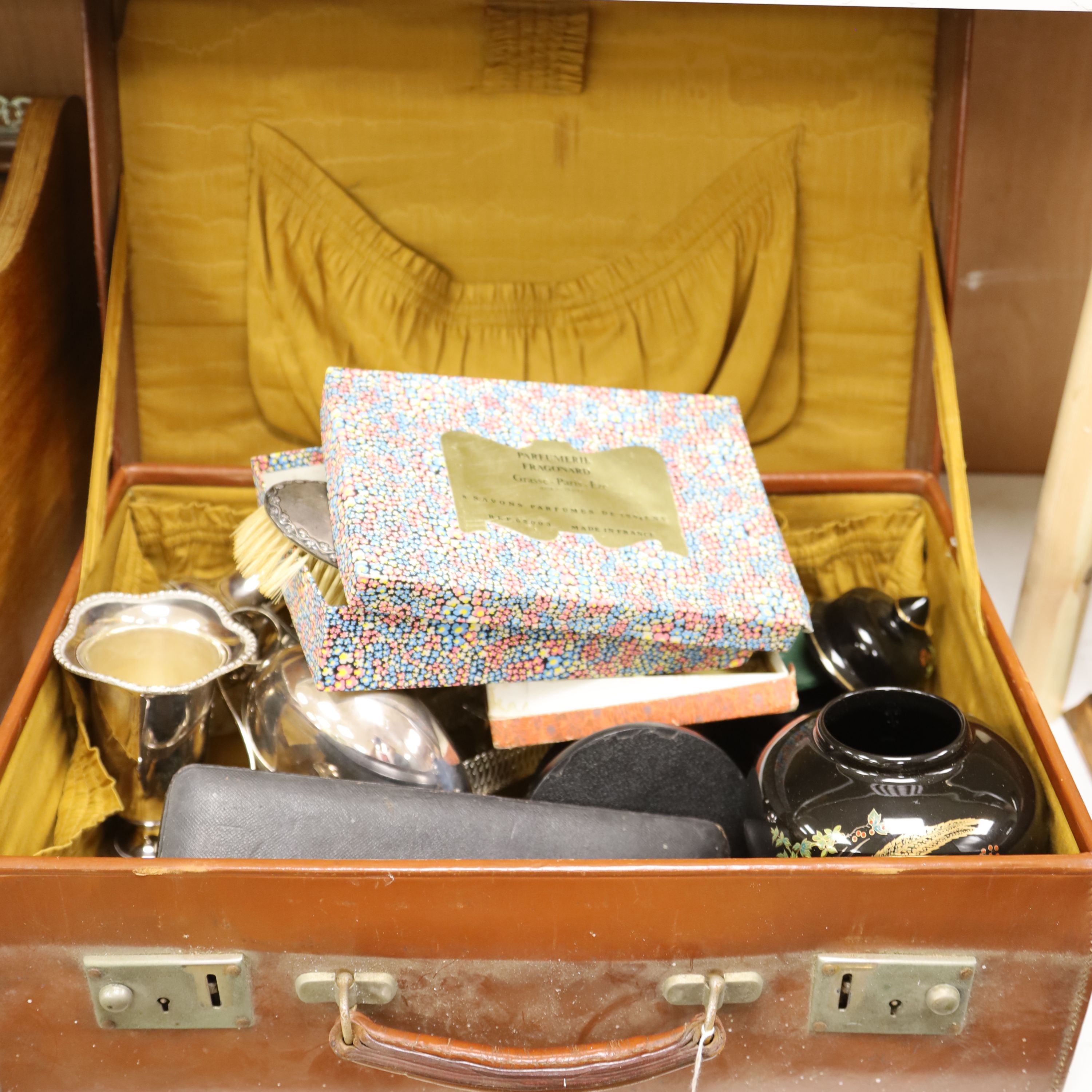 A leather case with collectables including a silver cigarette case, plated wares, a vase etc.